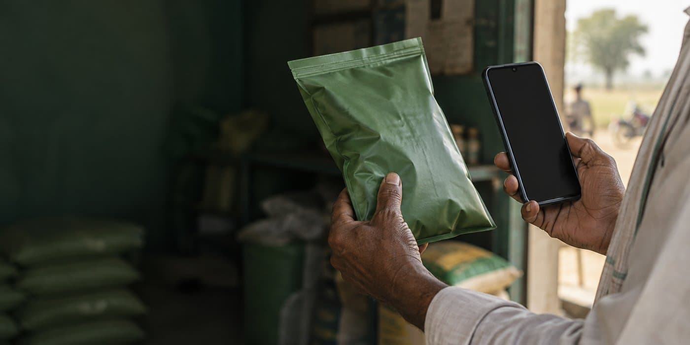 A Hiverta seed bag with its QR code being verified on a phone